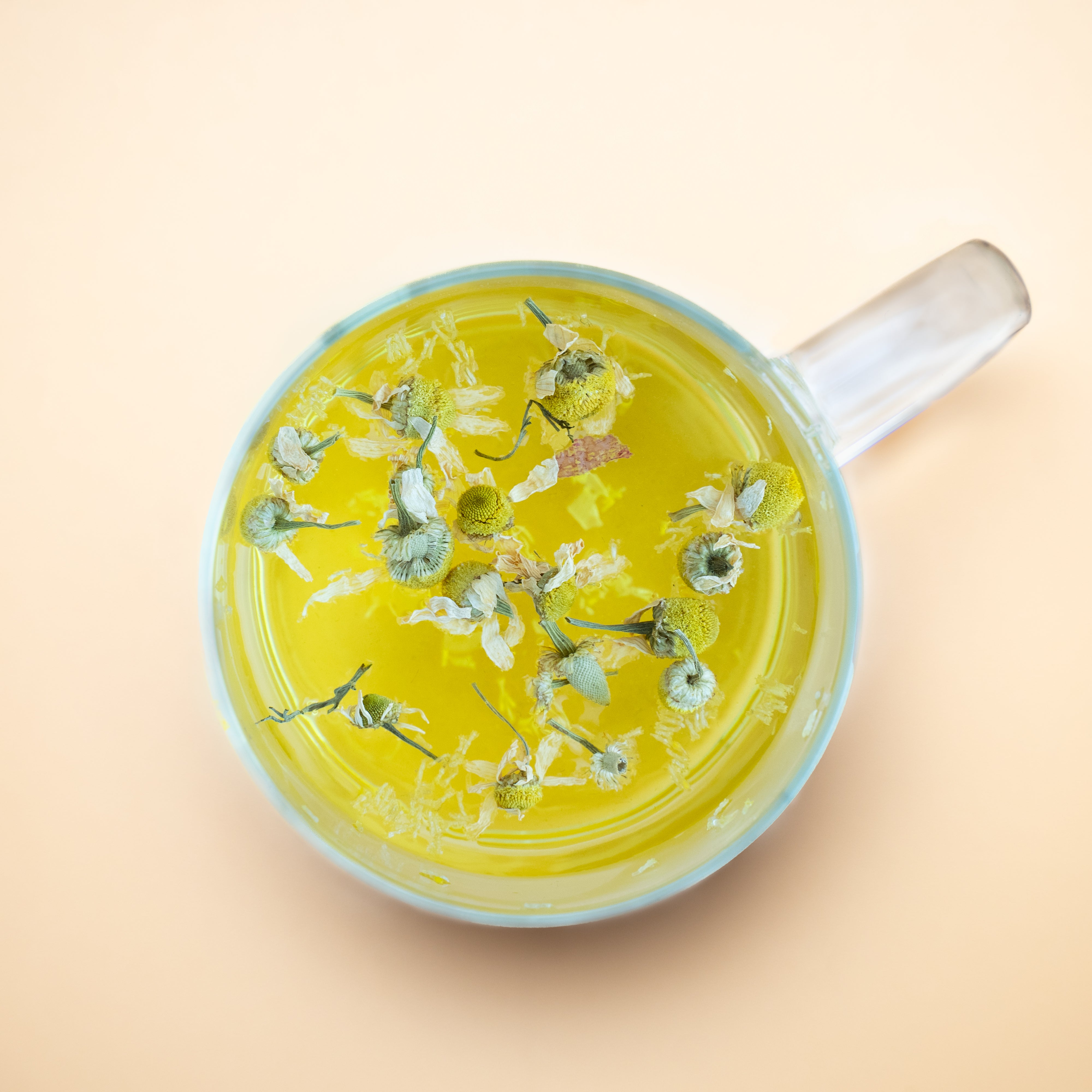 Loose chamomile flowers for calming herbal tea with golden floral tones