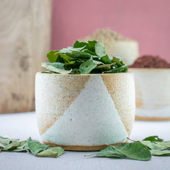 Freshly packed curry leaves highlighting their vibrant green color and aroma