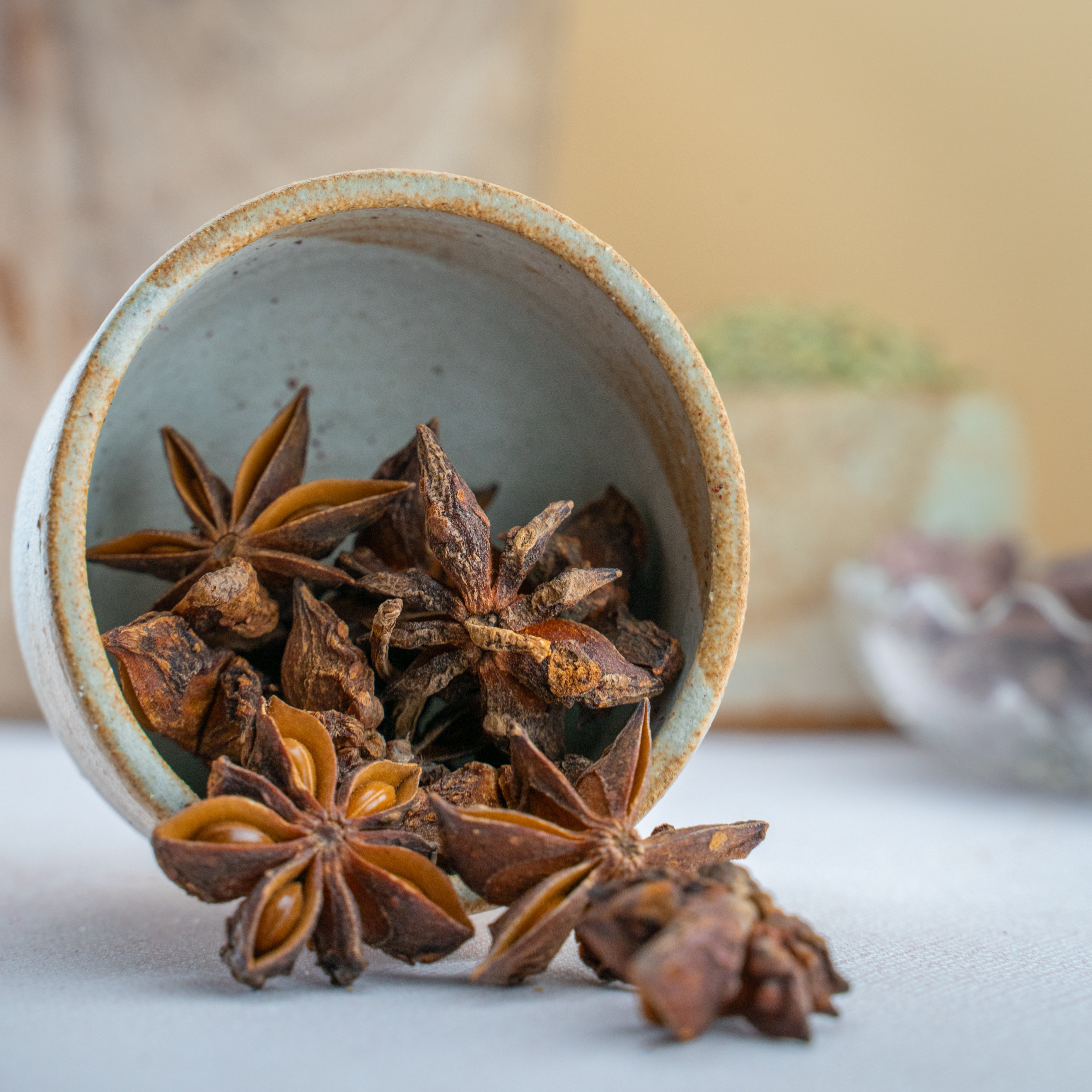 Whole star anise spice in decorative glass jar with bold licorice aroma